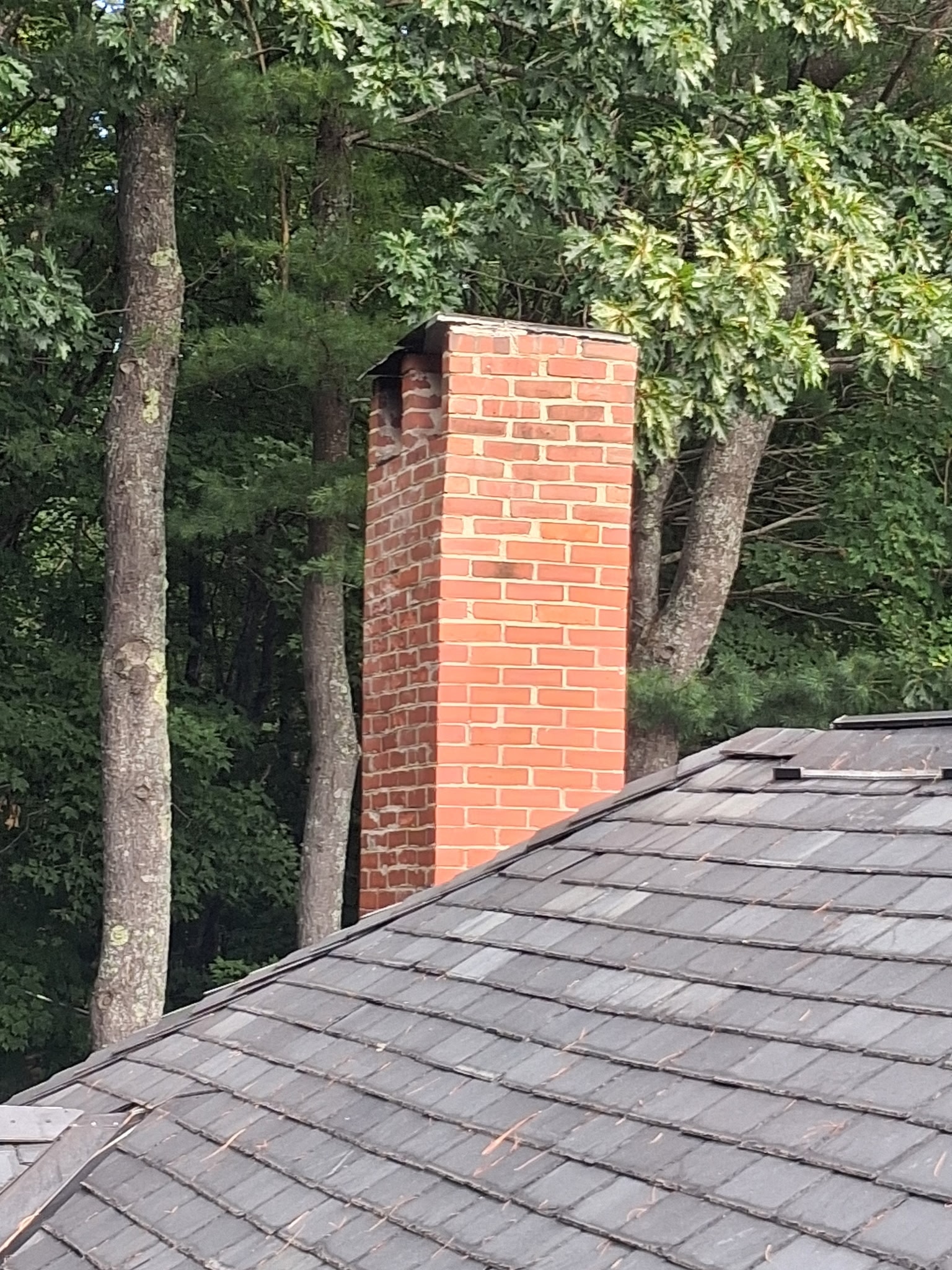 Chimney before restoration — deteriorated brick and mortar